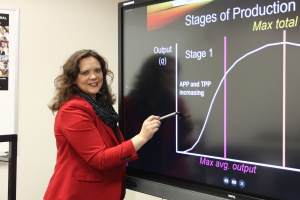 A photograph of Agriculture Instructor Ryan Wildman pointing to a smart board as she instructs a class.