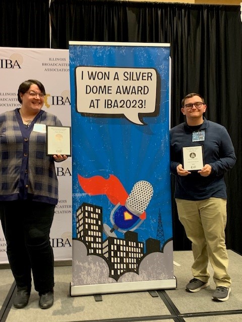 Two Lake Land broadcasting students posing with their first-place awards at the Illinois Broadcasters Association award event. 