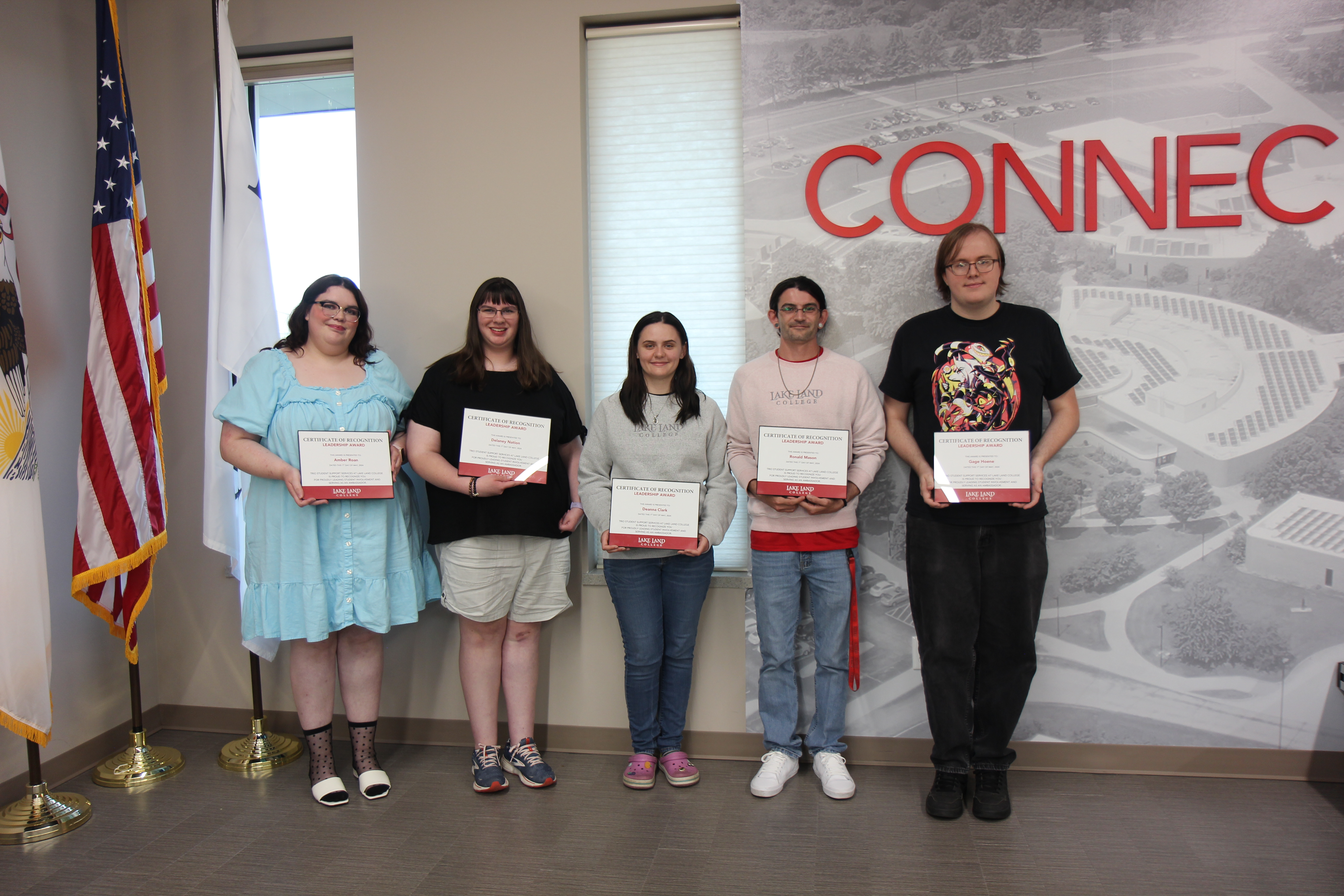 Five Lake Land College TRIO Students holding awards at a banquet