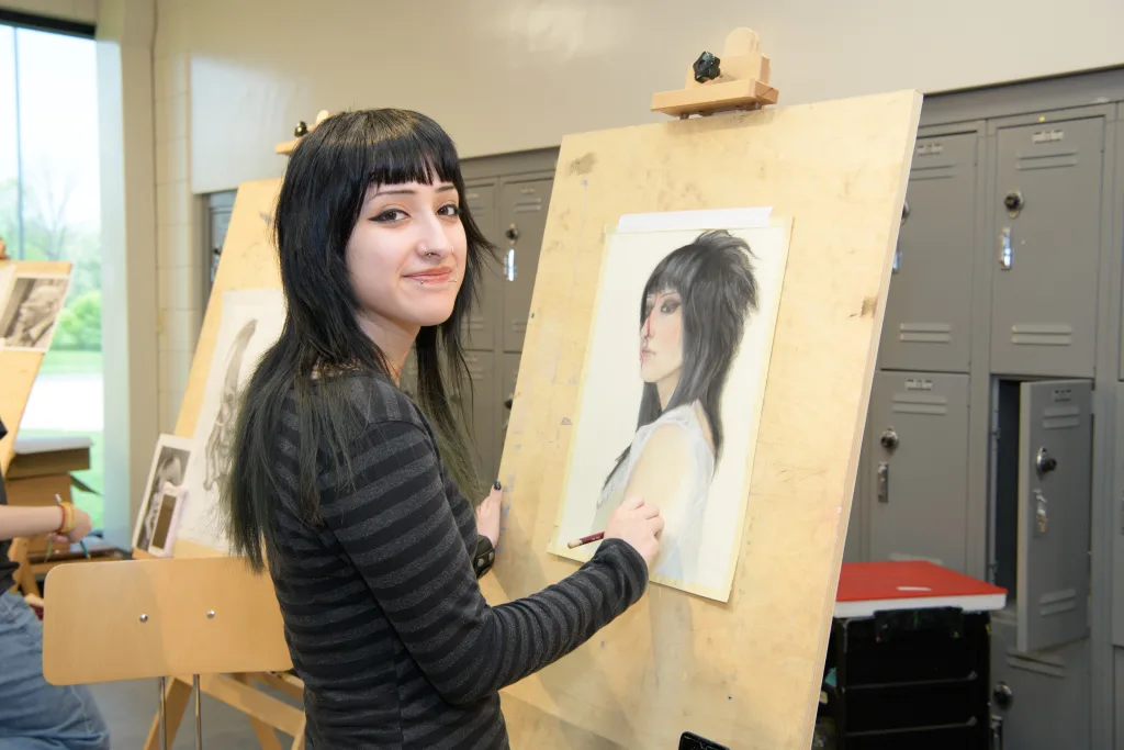 Photo of art student painting self portrait