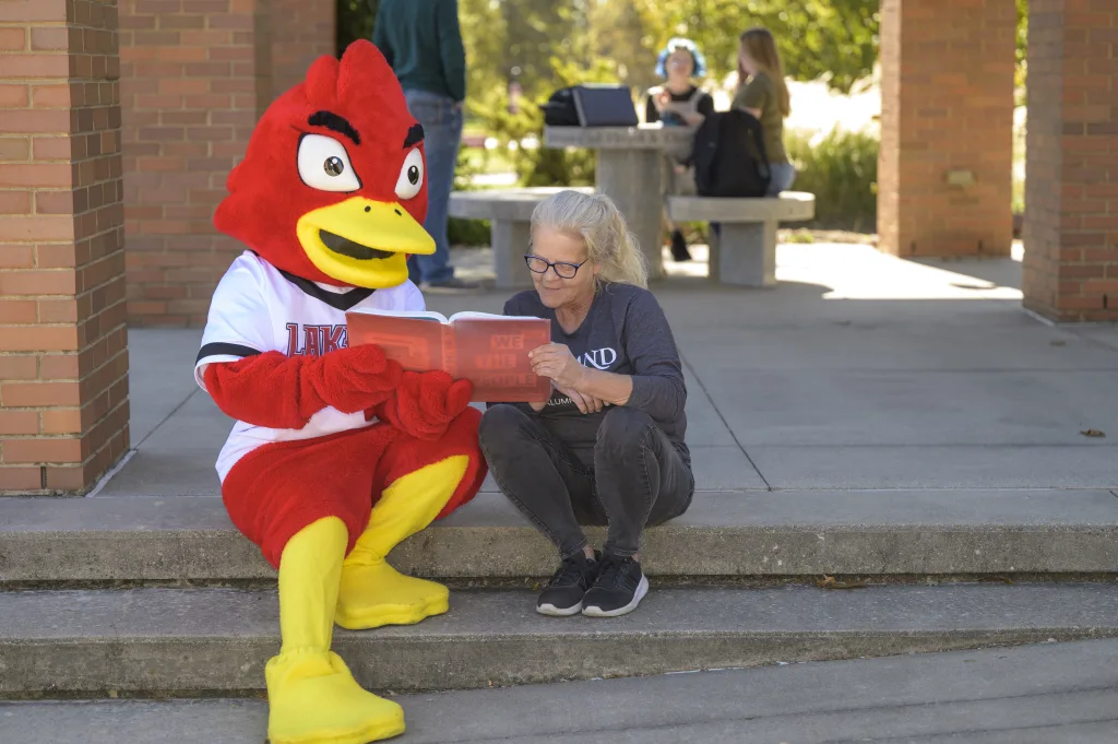 Laker Louie reading to someone