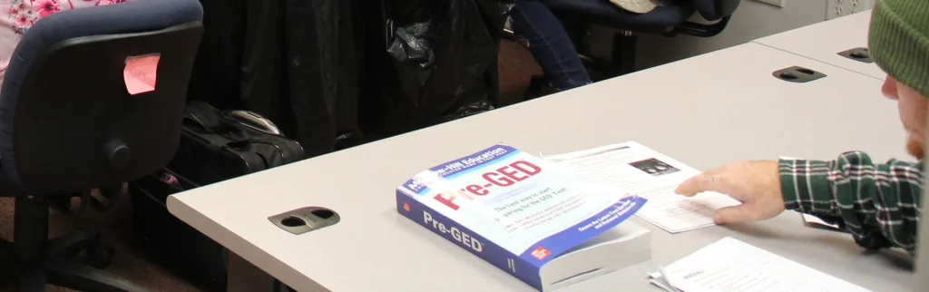 Adult education pre-GED student with book