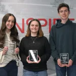Students holding an award and posing for a photo