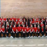 Nursing students posing for a photo sitting on steps