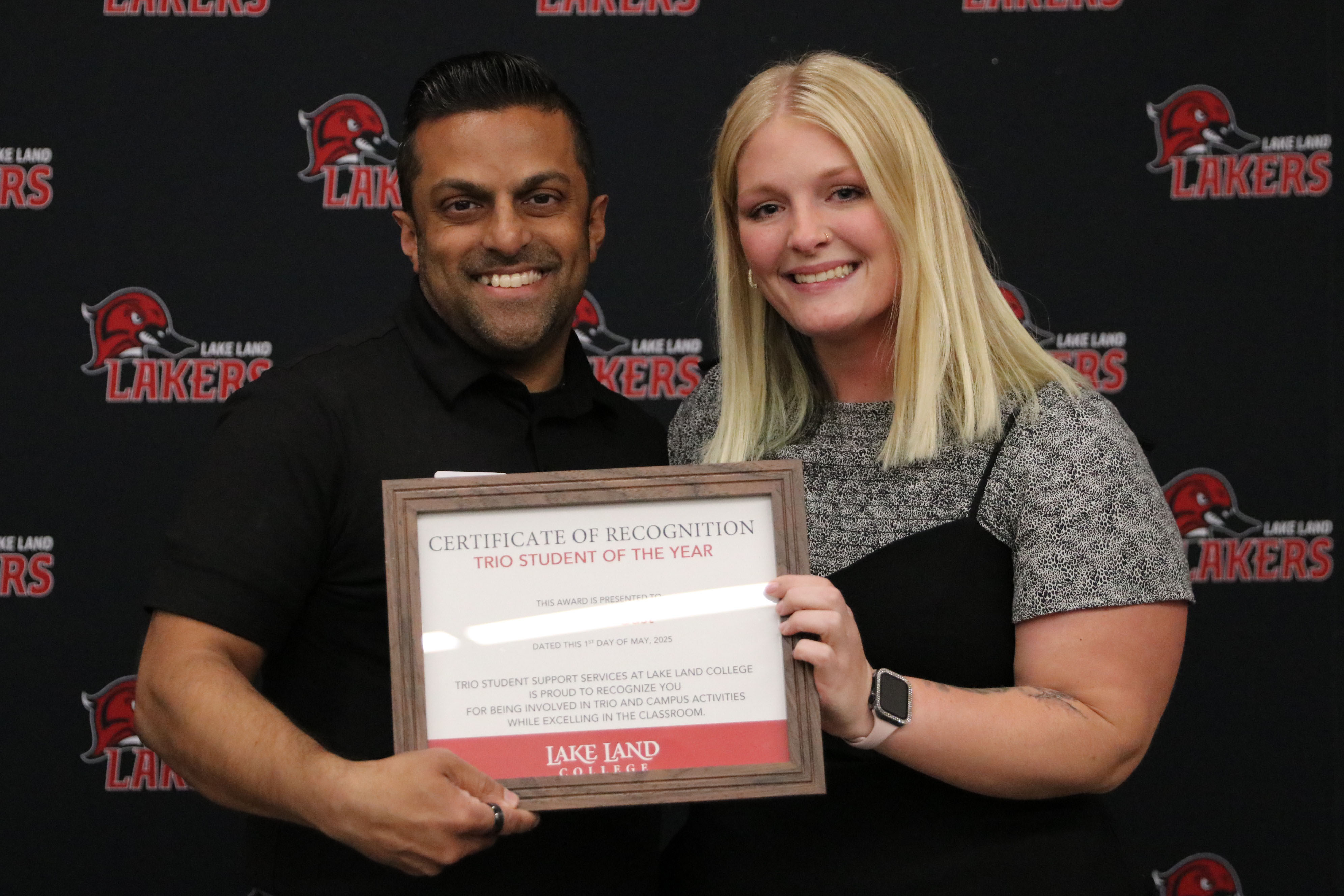 A student receiving an award at a banquet.