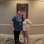 Students posing for a photo wearing medals