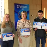 Students and instructor holding certificates and posing for a photo