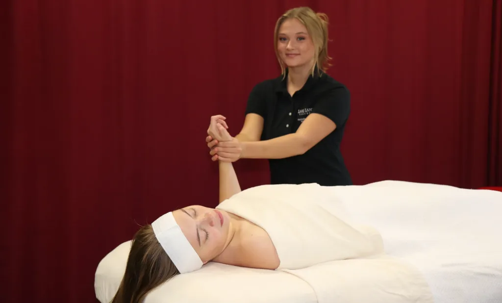 Massage therapy student giving a massage to a patient