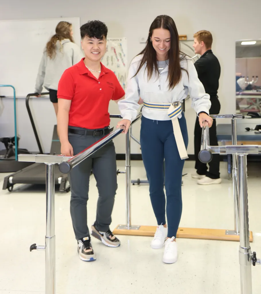 Physical therapy student helping a patient with an exercise