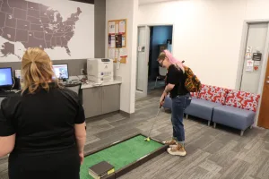A student playing mini gofl