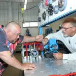 A student and instructor in a manufacturing lab.