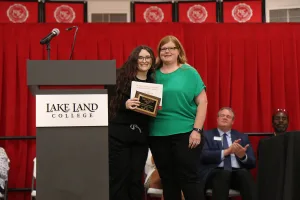 A Medical Assistant program graduate receiving an award during a pinning ceremony.