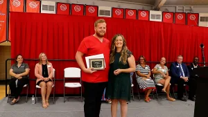 A nursing student receiving an award during a pinning ceremony.