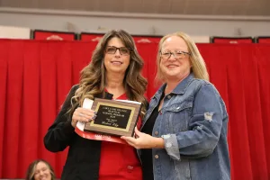 A nursing student receiving an award during a pinning ceremony.