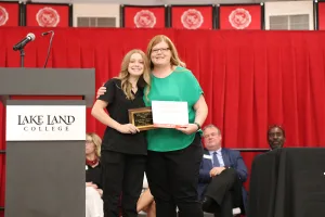 A Medical Assistant program graduate receiving an award during a pinning ceremony.