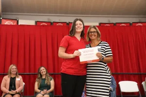 A nursing student receiving an award during a pinning ceremony.