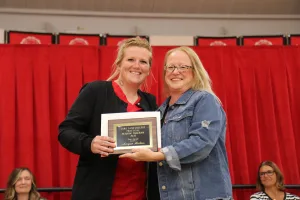 A nursing student receiving an award during a pinning ceremony.