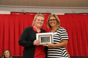 A nursing student receiving an award during a pinning ceremony.
