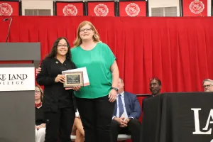 A Medical Assistant program graduate receiving an award during a pinning ceremony.