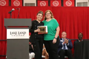 A Medical Assistant program graduate receiving an award during a pinning ceremony.