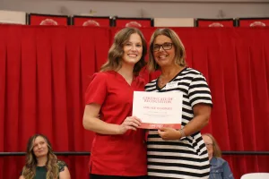 A nursing student receiving an award during a pinning ceremony.
