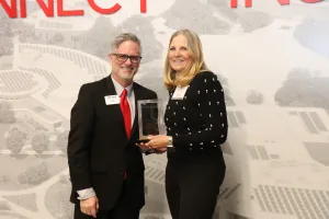 Lake Land College President Josh Bullock presents the Retiree Wall of Fame honor to Dr. Debora L.G. Hutti during the 2025 Lake Land College Foundation and Alumni Awards reception.