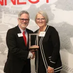 Lake Land College President Josh Bullock presents the Retiree Wall of Fame honor to Dr. Tina Stovall during the 2025 Lake Land College Foundation and Alumni Awards reception.