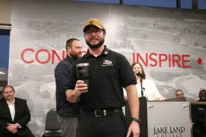 EMS Graduate Brand Balaco receiving the Bumble Bee Award for Untapped Potential during the Lake Land College 2025 EMS Pinning Ceremony.