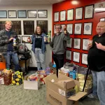 Members of the Lake Land College Broadcasting Club with the donations they collected for the club’s 19th annual food drive.