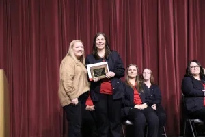 Nursing graduate Aimee Gooden receiving the Marilyn Fuqua Thompson Award during the Fall 2025 LPN to ADN pinning ceremony.