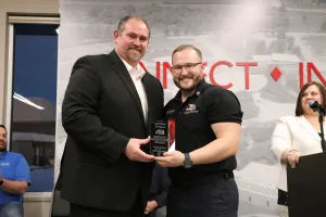 An EMS Instructor presenting an award to EMS graduate Grayson Thomas during the Fall 2025 EMS Pinning Ceremony.