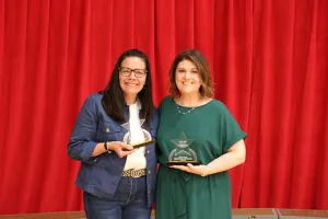 Dean for Workforce Solutions & Community Education Christine Strohl and Senior Designer & Brand Coordinator Megan Nelson receiving the 2026 Lake Land College Shine Award during the College’s annual employee recognition event. 
