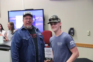 An image of Lake Land College Welding Instructor/Program Coordinator James Crowder presenting the 2nd Place Senior award to Colten Cottrell, South Vermillion High School, during the first-ever Laker Connect Dual Credit High School Welding Competition. 
