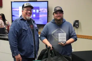 An image of Lake Land College Welding Instructor/Program Coordinator James Crowder presenting the 3rd Place Senior award to Evan Lay, Sullivan High School, during the first-ever Laker Connect Dual Credit High School Welding Competition. 