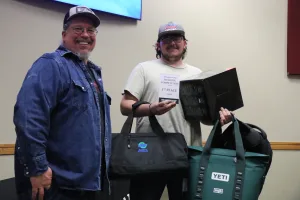 An image of Lake Land College Welding Instructor/Program Coordinator James Crowder presenting the 1st Place Junior award to Landen Miller, Mattoon High School, during the first-ever Laker Connect Dual Credit High School Welding Competition.