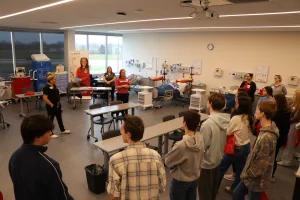 An image of Division Chair Allied Health/Nursing Instructor Erin Swingler, Allied Health Specialist Hilary Donley and Nursing Instructor/Director of Nursing Programs Cassandra Porter showcasing the Effingham Technology Center nursing labs to several high school juniors during Lake Land College’s Laker Day. 