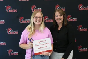 A student being recognized for completing honors courses at an annual banquet.