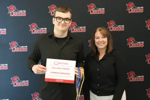 A student being recognized for completing honors courses at an annual banquet.