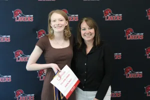 A student being recognized for completing honors courses at an annual banquet.
