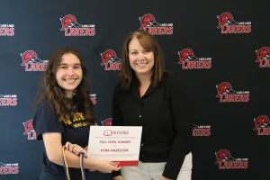 A student being recognized for completing honors courses at an annual banquet.