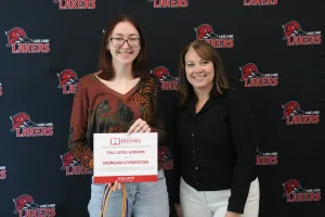 A student being recognized for completing honors courses at an annual banquet.