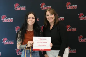 A student being recognized for completing honors courses at an annual banquet.