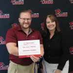 A student being recognized for completing honors courses at an annual banquet.
