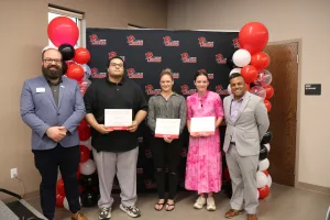 Two Lake Land College TRIO Staff members recognizing the students who were nominated for the Above and Beyond Award at the annual TRIO SSS Banquet. 