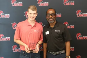 A student being recognized as a nominee for an award during a banquet.