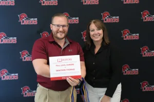 A student receiving the Honors Student of the Year Award from the Lake Land College Vice President of Student Services. 