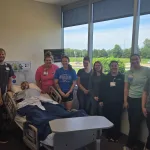 A group of nurses together at the Lake Land College Effingham Technology Center high-fidelity nursing simulation lab.