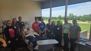 A group of nurses together at the Lake Land College Effingham Technology Center high-fidelity nursing simulation lab.