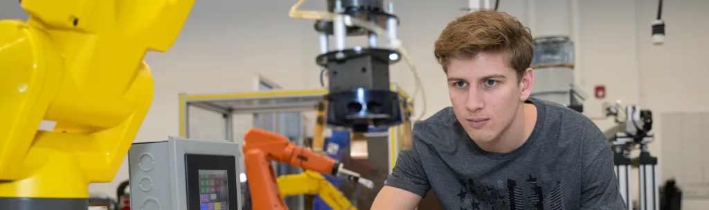 A photograph of a student using a machine.