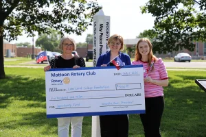 Mattoon Rotary Peacebuilder Committee Chair Tina Stovall presenting a $500 check to Lake Land College representatives.